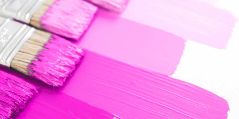 five shades of pink paint on brushes